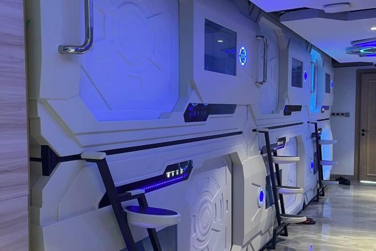 A row of spa-like rooms with individual seating areas and control panels.