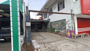 A building with a sign reading "Hotel Agung" and a motorcycle parked in front. - Hotel O Dian Asih Rooms (Demak)