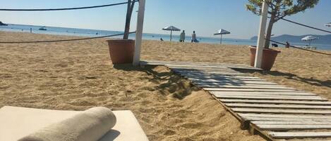 On the beach, sun-loungers
