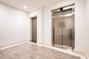 Elevators feature a digital display panel and sleek design.