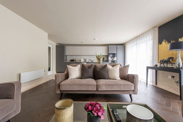 Relax in this stylish living room with a sofa, coffee table, and dining area.