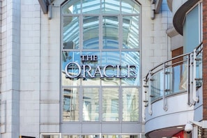 The Oracle building features a curved glass facade and a prominent sign.
