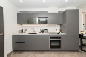 Enjoy cooking in this well-equipped kitchen with an oven and stainless steel sink.