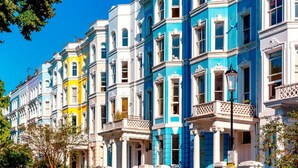 A row of colorful Victorian-style buildings with ornate facades and balconies.