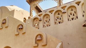 A building with arched doorways and decorative cutouts. - Harmony Villas Sleeps 4 With Garden (Luxor)