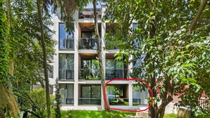 A multi-story residential building with balconies, surrounded by lush greenery. - Hotel Squero (Rovinj)