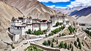A monastery complex with multiple buildings, including a large central structure with a golden dome, surrounded by smaller buildings and pathways. - Hotel Ladakh Marvel Leh (Leh)