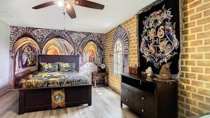 A bedroom with a large bed, a dresser, and a ceiling fan. - Palm Paradise Haven (Four Corners)