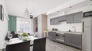A modern kitchen with a dining area.