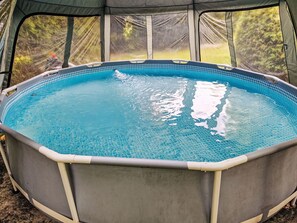 Enjoy a refreshing dip in this outdoor pool, surrounded by a shaded tent.