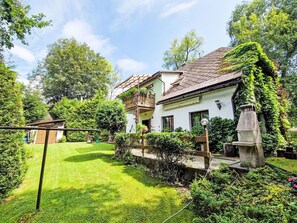 Experience the serene charm of this countryside house, surrounded by lush greenery and a beautifully maintained garden.