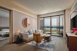 Deluxe Suite | Living area | 65-inch TV with satellite channels