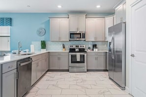 - Kitchen features a modern design with plenty of storage and counter space, perfect for preparing meals  - Integrated appliances contribute to the seamless and stylish appearance - Kitchen essentials are thoughtfully placed for easy access - Disney near Resort 9BR Home Oasis w/ Pool (Kissimmee)