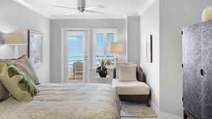 A bedroom with a bed, a desk, a chair, a ceiling fan, and a window with blinds. - An Ocean Serenity at the Truman Annex in Key West (Key West)