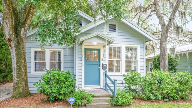 A light blue house with a green door, white windows, and a blue front porch. - Uptown Escape – Sleeps 6, Pet & Family Friendly (St. Augustine)
