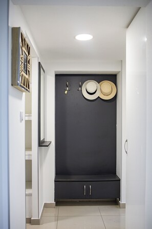 Guests can relax in the hallway, featuring a bench with personal storage hooks.
