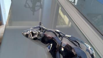 A shiny metallic bull figurine on a reflective surface.