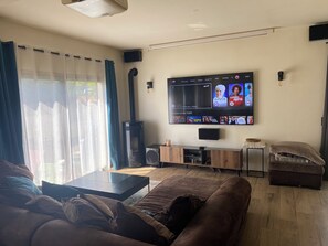 Relax in this cozy living room with a flat-screen TV, comfortable sofa, and coffee table.