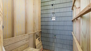 A wooden shower stall with a showerhead and a wooden bench. - Luxury Oceanfront Home: Private Pool, Elevator Access, Game Room & More! (Emerald Isle)
