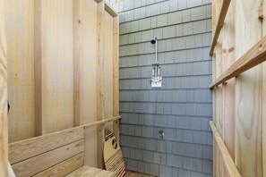 A wooden shower stall with a showerhead and a wooden bench. - Luxury Oceanfront Home: Private Pool, Elevator Access, Game Room & More! (Emerald Isle)