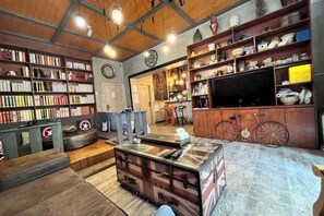 Relax in a well-organized living space with a sofa, bench, and dining table.
