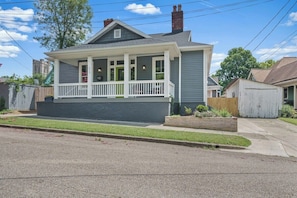 A single-story house with a front porch, a small front yard, and a garage. - Historic 4th and Gill Charmer (Mid-Term Available) (Knoxville)