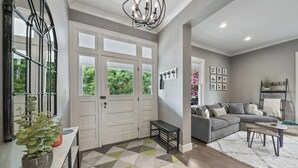 A modern living room with a grey sofa, a coffee table, and a patterned rug. - Historic 4th and Gill Charmer (Mid-Term Available) (Knoxville)
