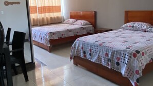 A hotel room with two single beds, a desk with a chair, and a window with curtains. - Royal Amazon (Coca)