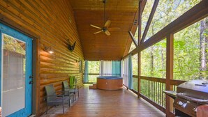 A covered porch with a wooden ceiling, a hot tub, and a grill. - Private Couples' Retreat Near Beavers Bend (Broken Bow)