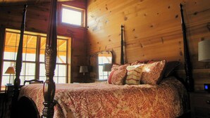A wooden cabin bedroom with a four-poster bed, a ceiling fan, and large windows. - Cozy private Cabin Farm stay with WiFi in Irvine (Irvine)