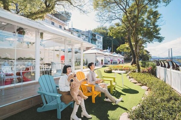 A patio area with outdoor seating and a view of the water.