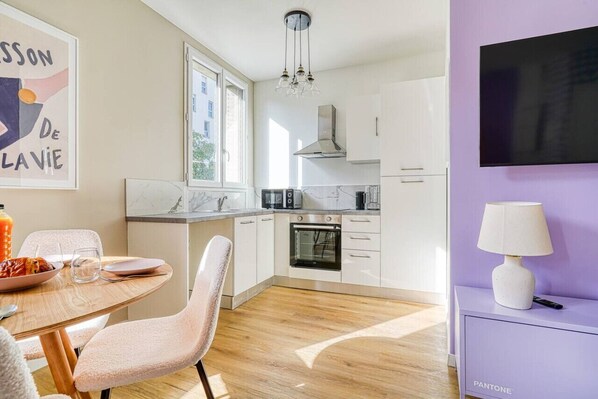 Enjoy cooking in this well-equipped kitchen with a stainless steel range hood, oven, and microwave.