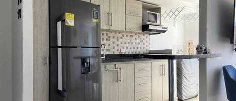 Fridge, microwave, stovetop, coffee/tea maker