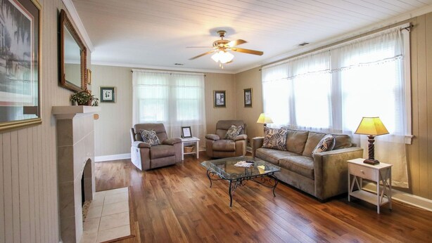 A living room with a fireplace, two armchairs, a sofa, and a coffee table. - Miss Audrey’s House is a charming cottage in the heart of historic Richmond Hill (Richmond Hill)