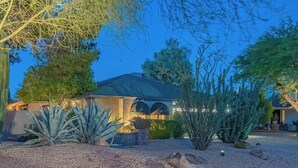 A house with a covered patio, surrounded by desert plants and a large tree. - Scottsdale Treasure: Private Pool and Tranquil Yard Retreat! (Scottsdale)