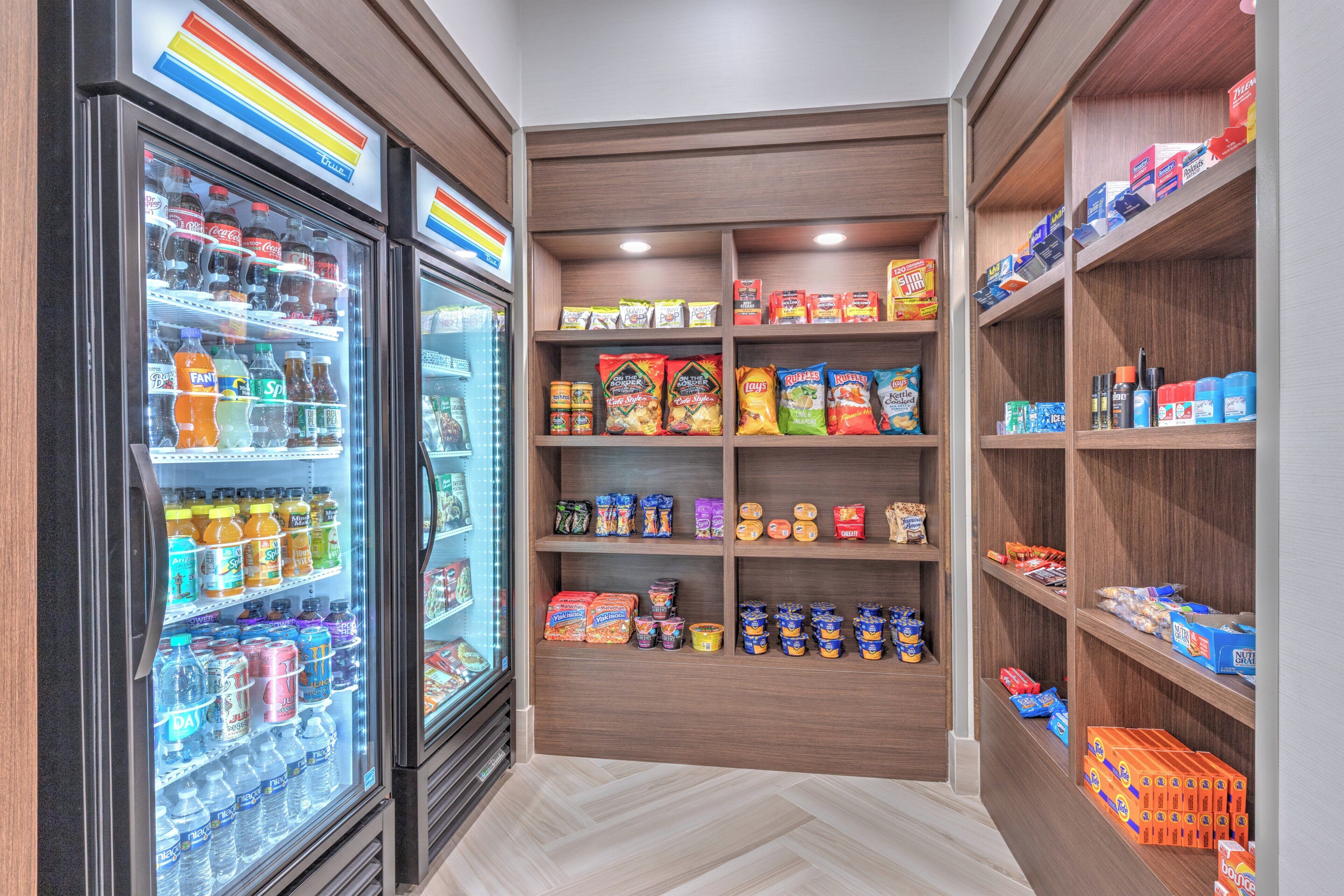 A well-organized pantry with shelves stocked with snacks, beverages, and condiments.