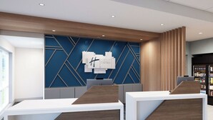A modern hotel reception desk with a geometric wall design and a wooden accent panel. - Holiday Inn Express & Suites Laramie West (Laramie)