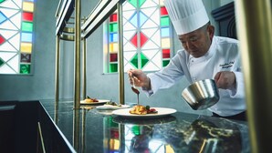 A chef in a white uniform pouring sauce onto a dish. - Hotel Indigo Nagasaki Glover Street by IHG (Nagasaki)
