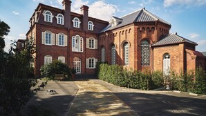 A large brick building with multiple windows and a central courtyard. - Hotel Indigo Nagasaki Glover Street by IHG (Nagasaki)