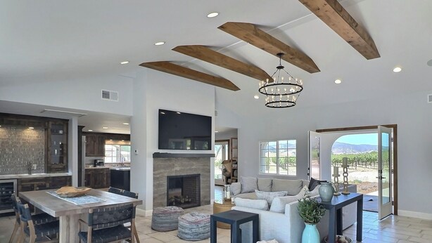 A spacious living area with a fireplace, a dining table, and a sofa.