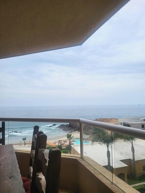 Enjoy the ocean view from this balcony overlooking the beach and pool.