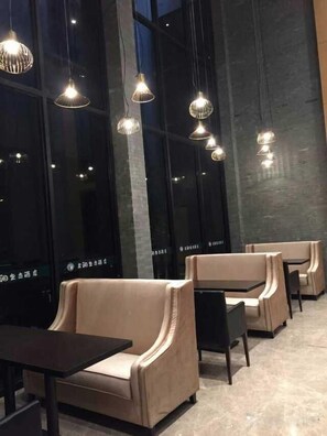 A modern interior with seating arrangements and pendant lighting. - Gurun Eco Hotel (Luoyuan)