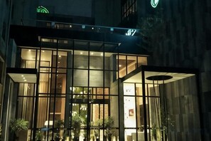 A modern building with large windows and a glass facade, likely a hotel or office. - Gurun Eco Hotel (Luoyuan)