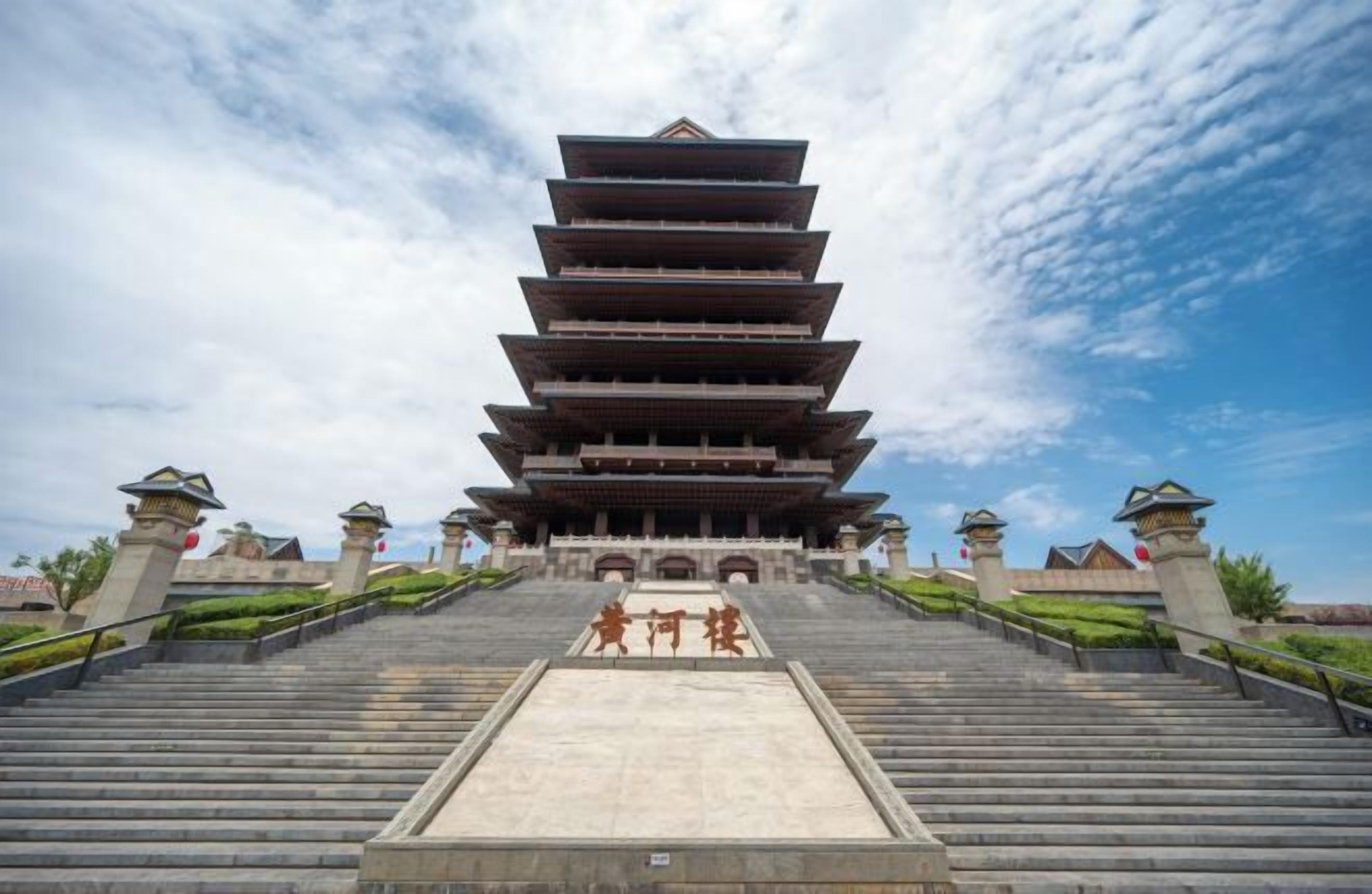 A traditional multi-tiered pagoda with a stone staircase leading up to it.