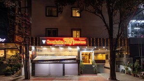 A hotel named "Suraksha Stay Deluxe Rooms" with a closed coffee shop and a staircase leading to the entrance. - Suraksha Stay Brookfield  (Bengaluru)
