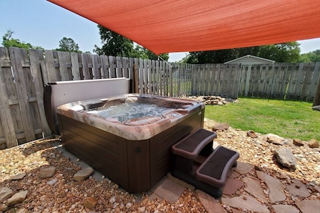 Outdoor spa tub. Doodlebug Cottage ~ Pool + Hot Tub Oasis + Close to I-95