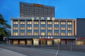 A hotel with a modern facade, multiple floors, and a prominent entrance. - Shenzhen Liuliu Hotel (Shiyan Bus Station) (Shenzhen)