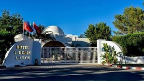 The entrance to Hotel L'Ecrin Garos with a white gate and flags. - Hôtel Écrin hamammet  (Hammamet)