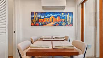 Dining for four, beside the closet.