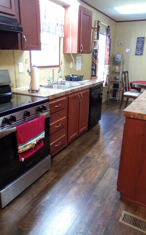 Enjoy cooking in this well-equipped kitchen with a central island, sink, and stovetop.
